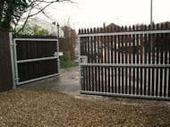 Steel-framed gates with timber picket pales